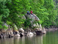 Youth Perch on Rocks Along the Occoquan Reservoir Shoreline